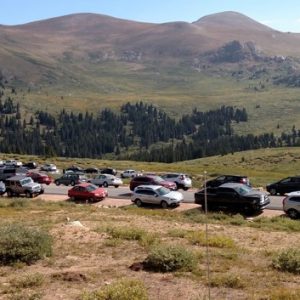 road lined with cars at park in Colorado